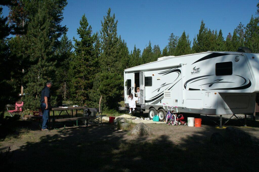 family with RV in campsite