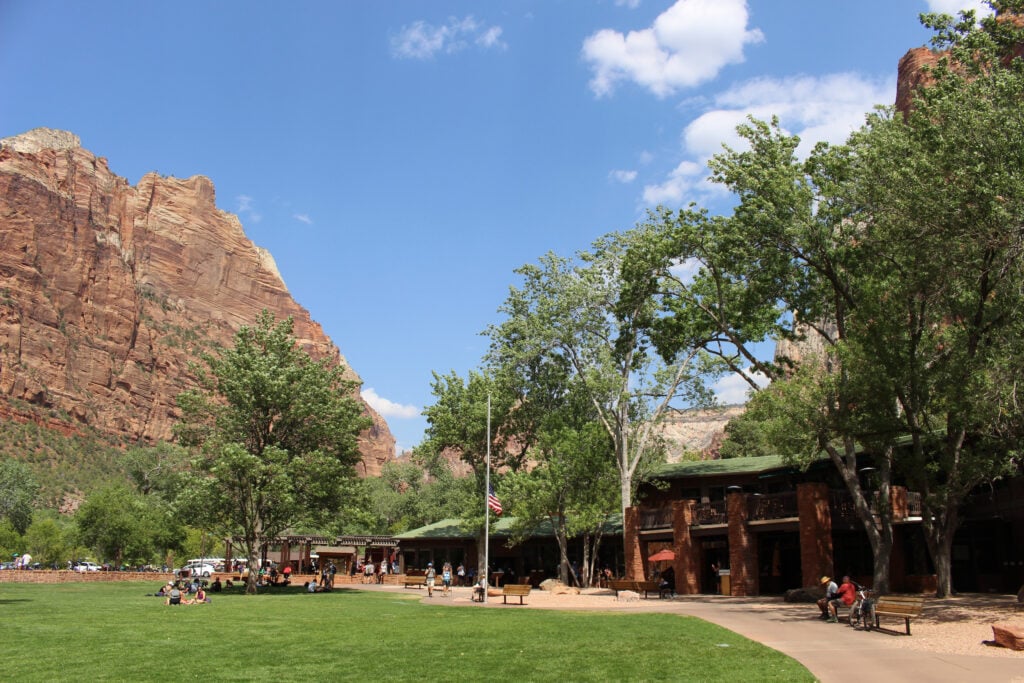 people walking around the outside of the Zion Lodge