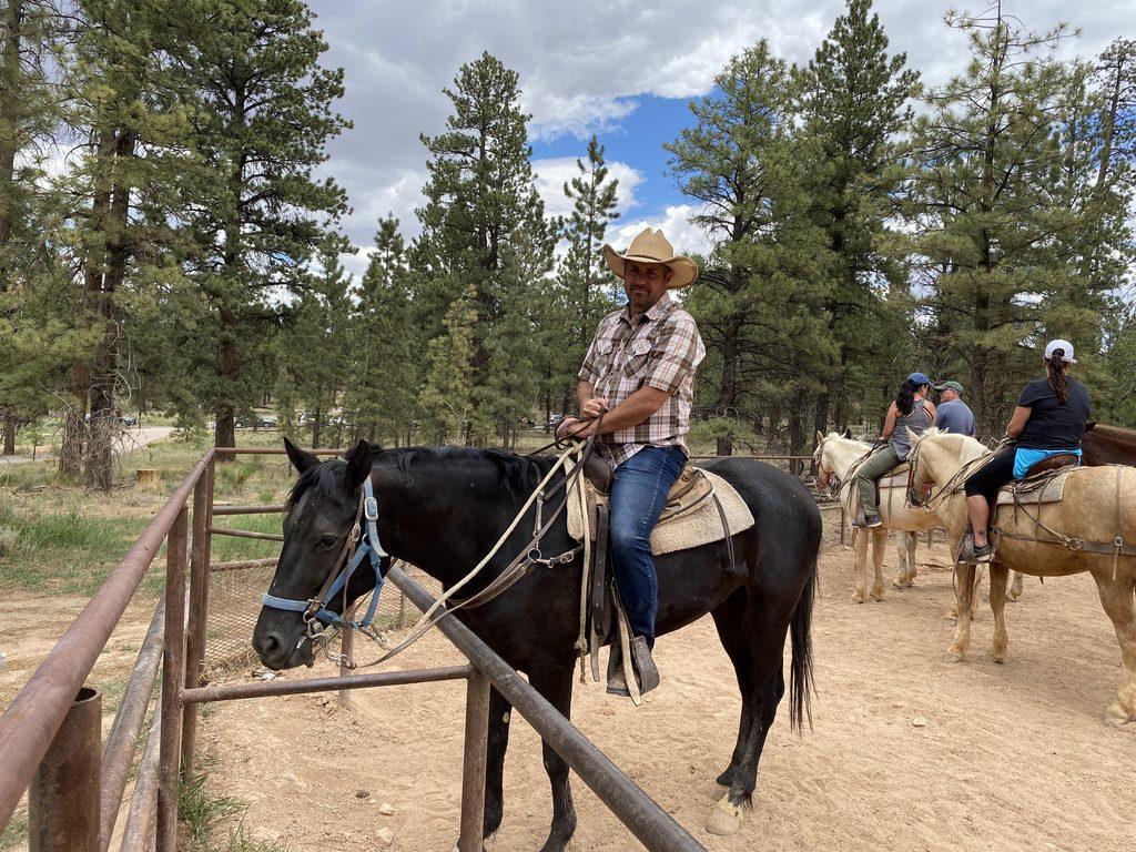 man on horseback in stable