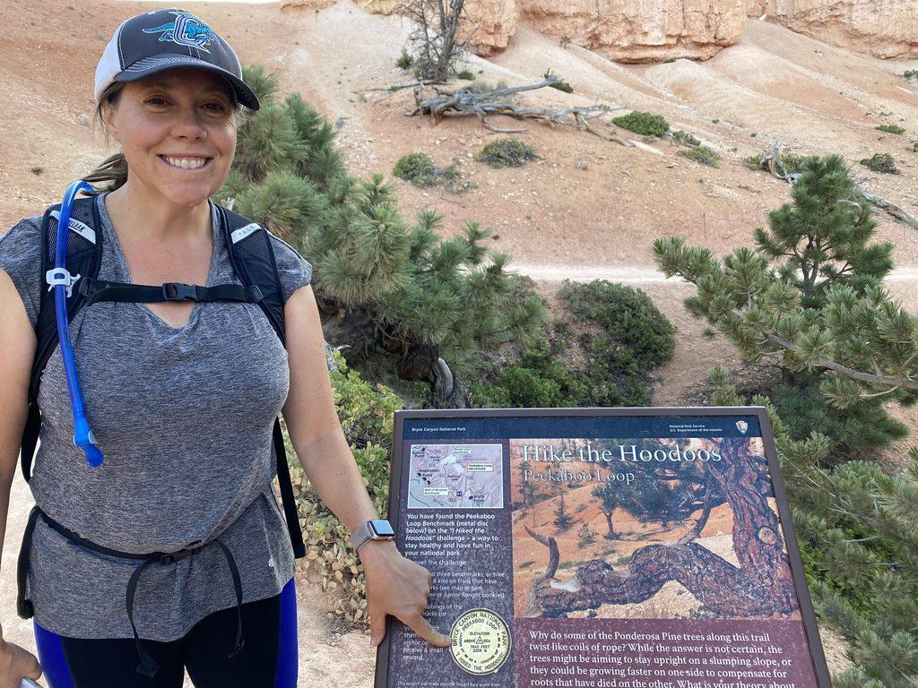 woman looking at informational sign in Bryce Canyon