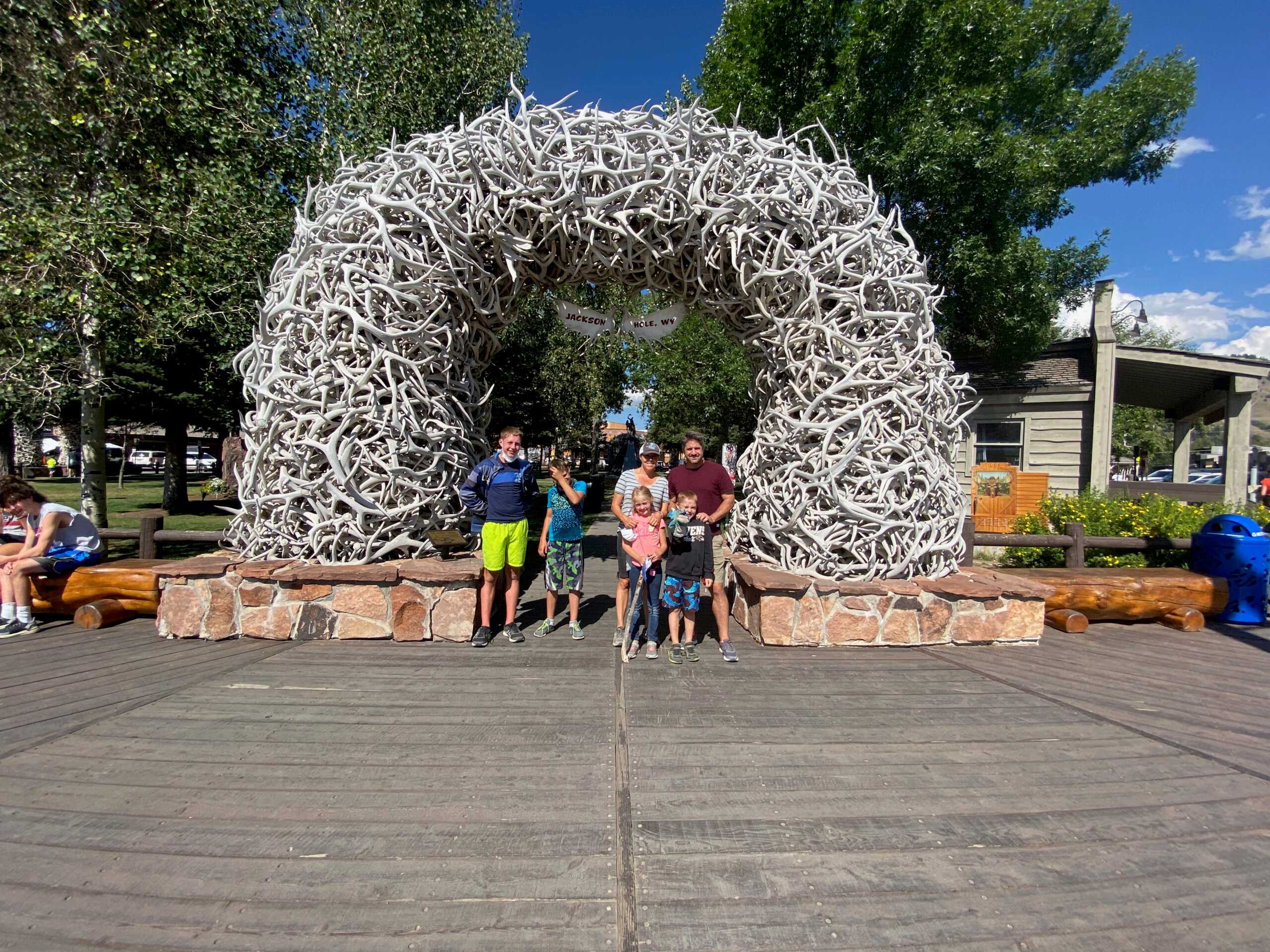 family standing under elk antler arch