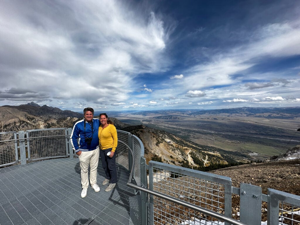 Teton Mountain Range from the Teton Skywalk with man and woman standing on the platform