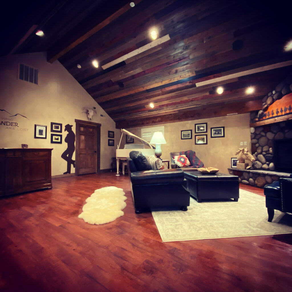 lobby with fireplace, couches, and white piano in inn