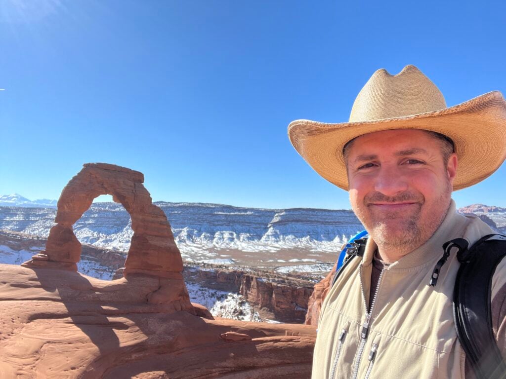 man in front of delicate arch