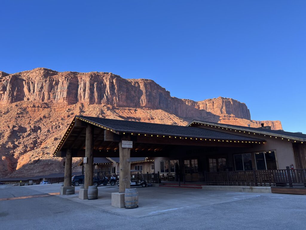 front entrance of Red Cliffs Lodge with red rock cliffs in the background