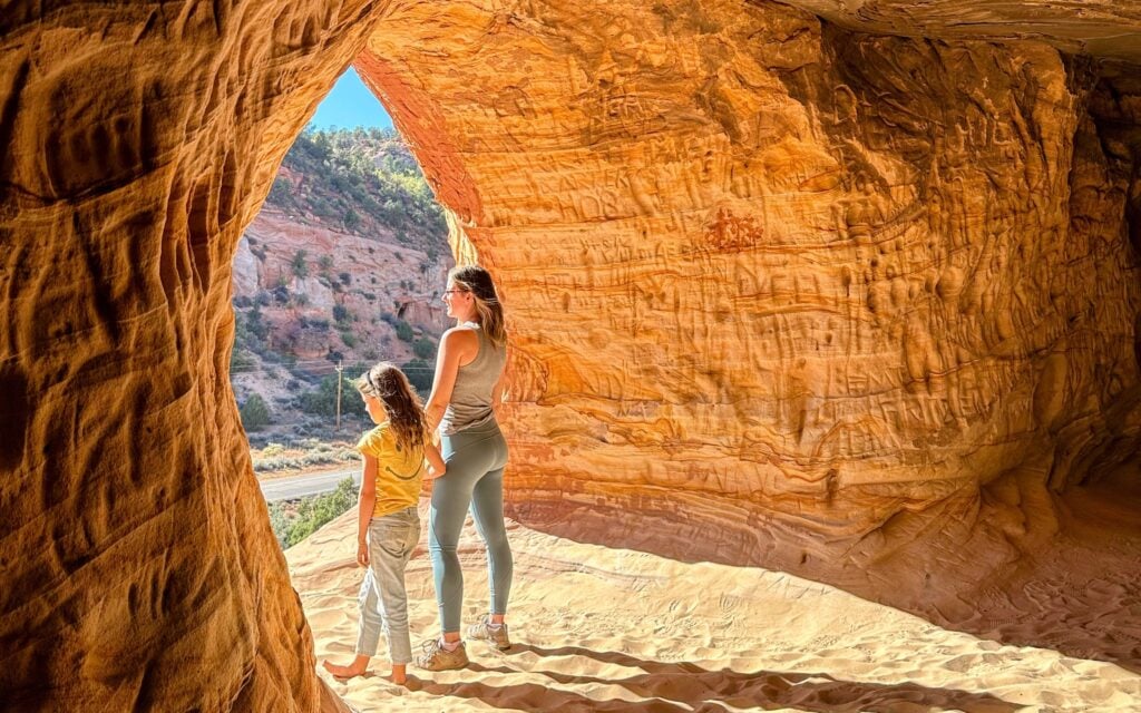 people standing in sand caves