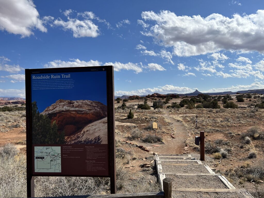 hiking trail with sign at trailhead
