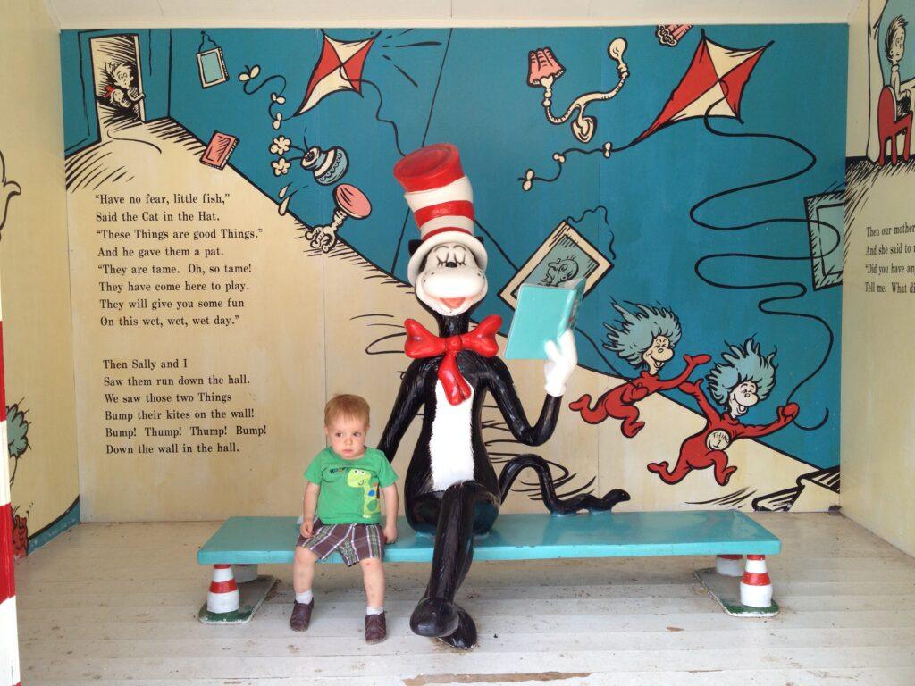 little boy next to statue of The Cat in the Hat