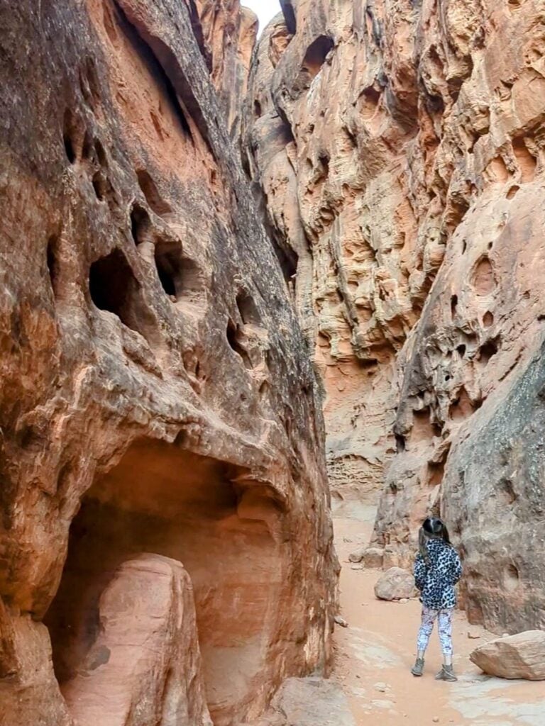 girl walking through slot canyon