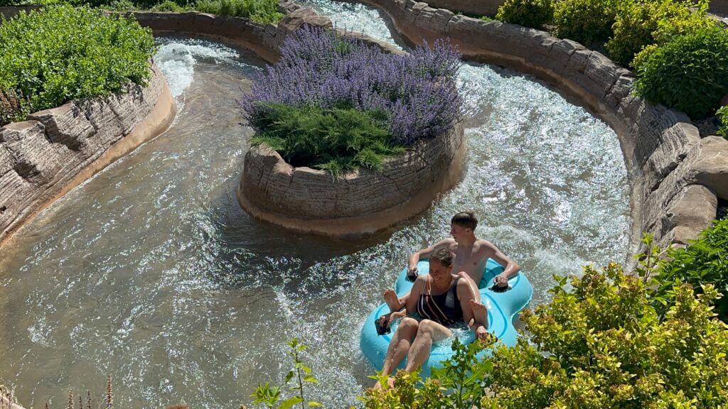 Boy and woman floating on a tube on lazy river waterslide