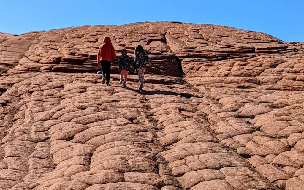 kids walking up petrified dunes