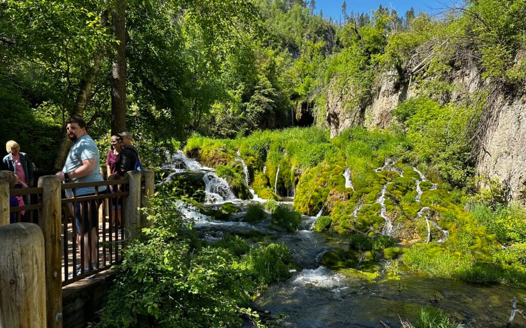 people standing on boardwalk near Roughlock Falls