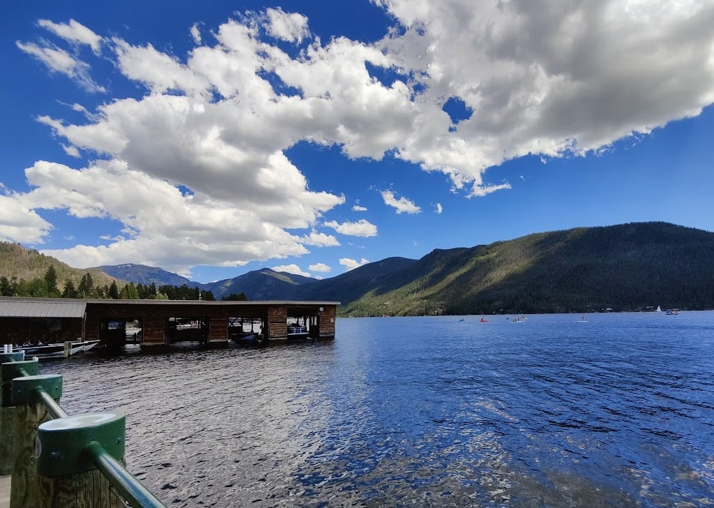 water, clouds, blue sky, lake, dock, paddleboards, canoes