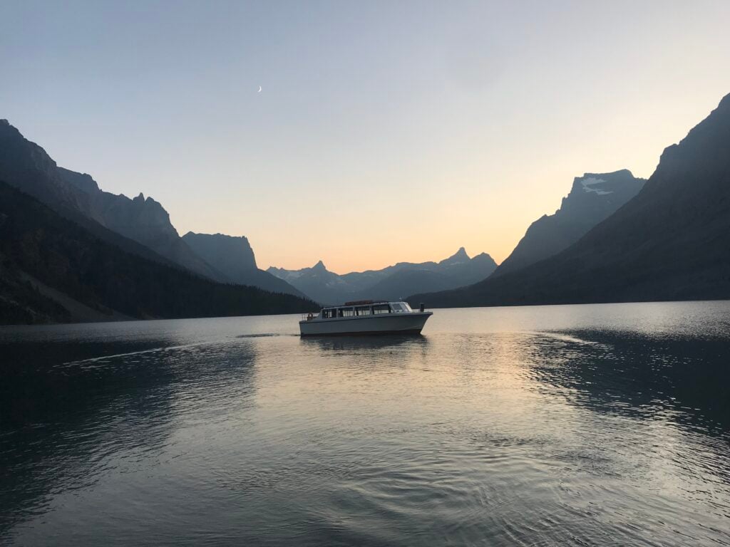 boat on lake in mountains during sunset