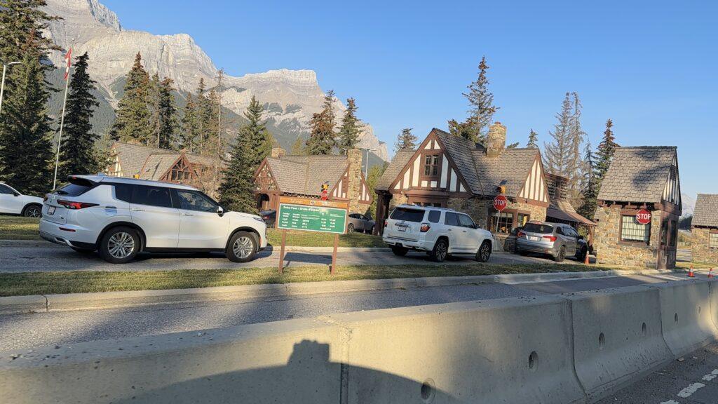 cars lined up at entrance to national park