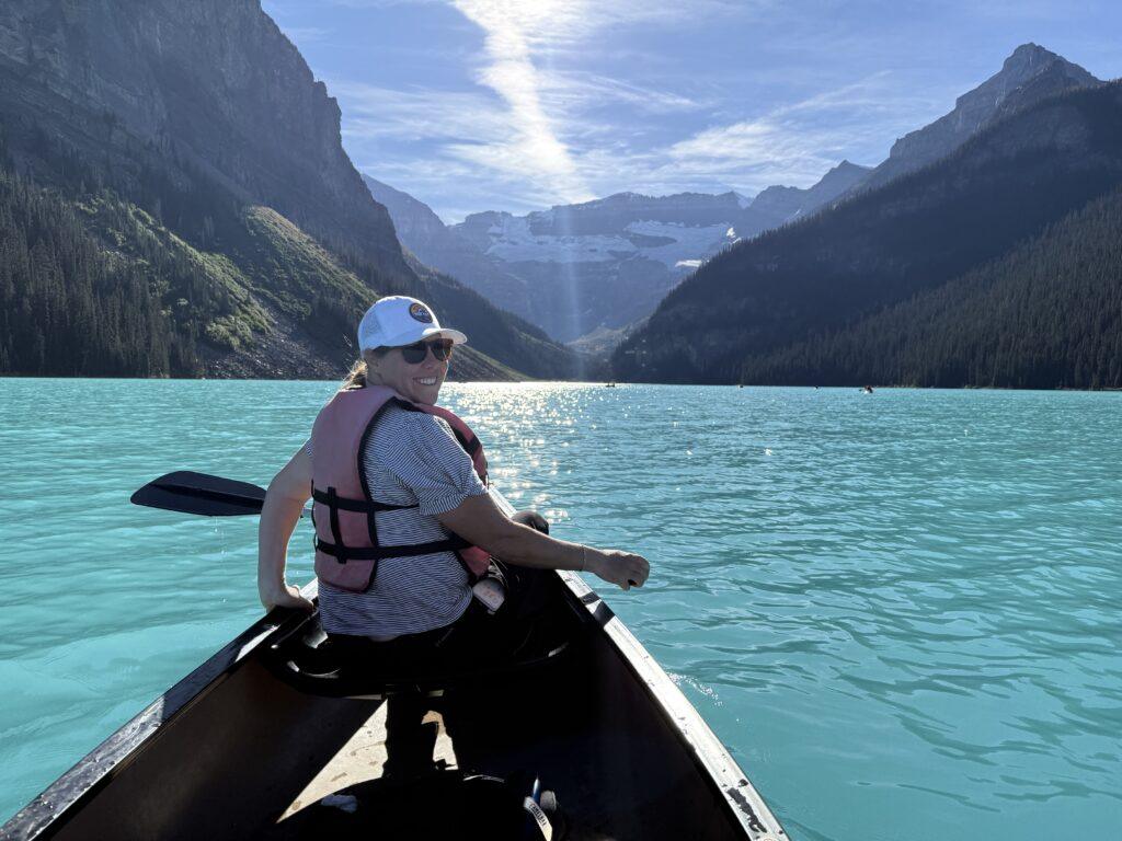 woman in canoe on glacial lake