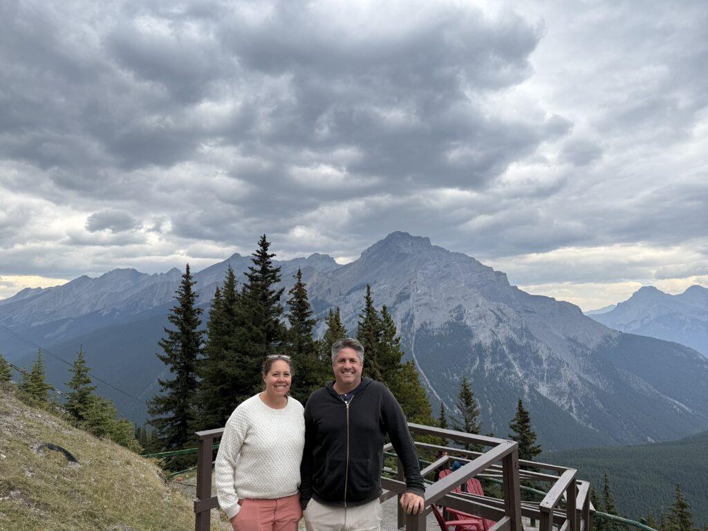 man and woman at mountain viewpoint