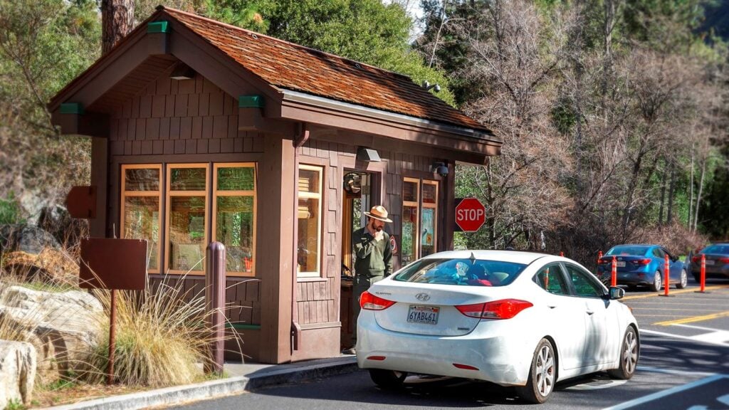 ranger and car at entrance booth to Yosemite