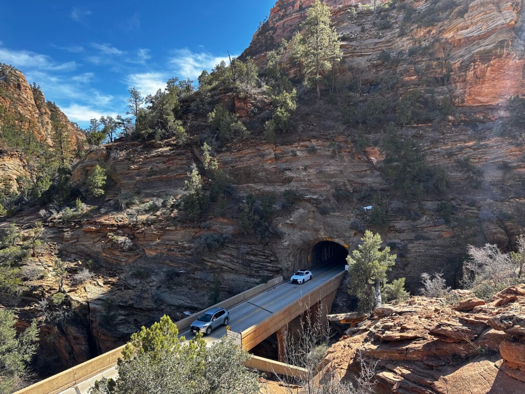 cars driving through mountain tunnel