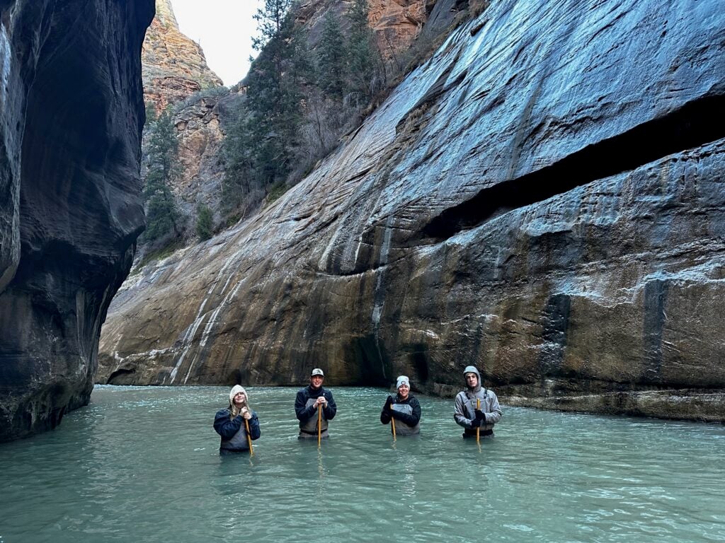 people standing in water on the Narrows Hike in Zion