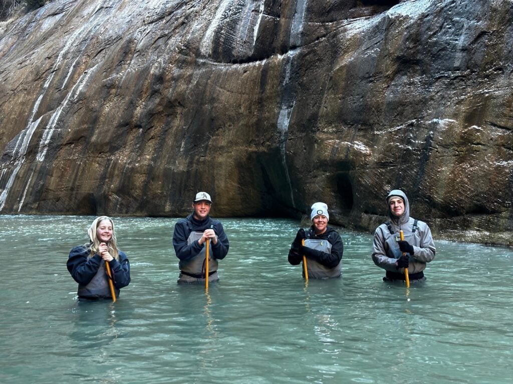 people standing in river