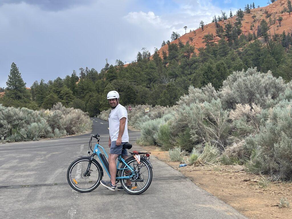 man standing with bike on path in Bryce Canyon