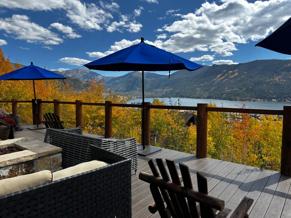 Blue umbrella with a lake and mountains in the background