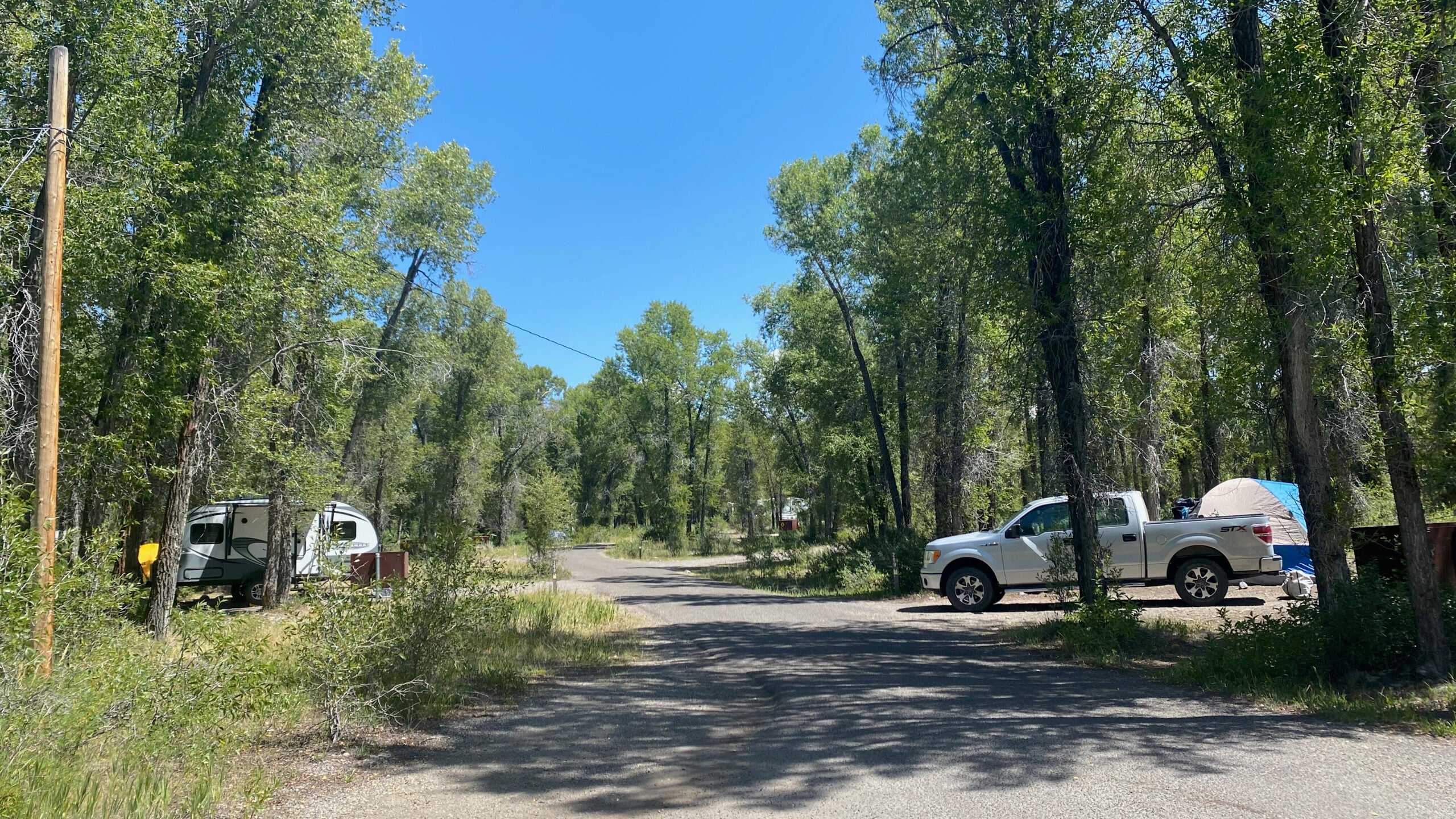 Camper, Truck, and Tents at Gros Venture Campground