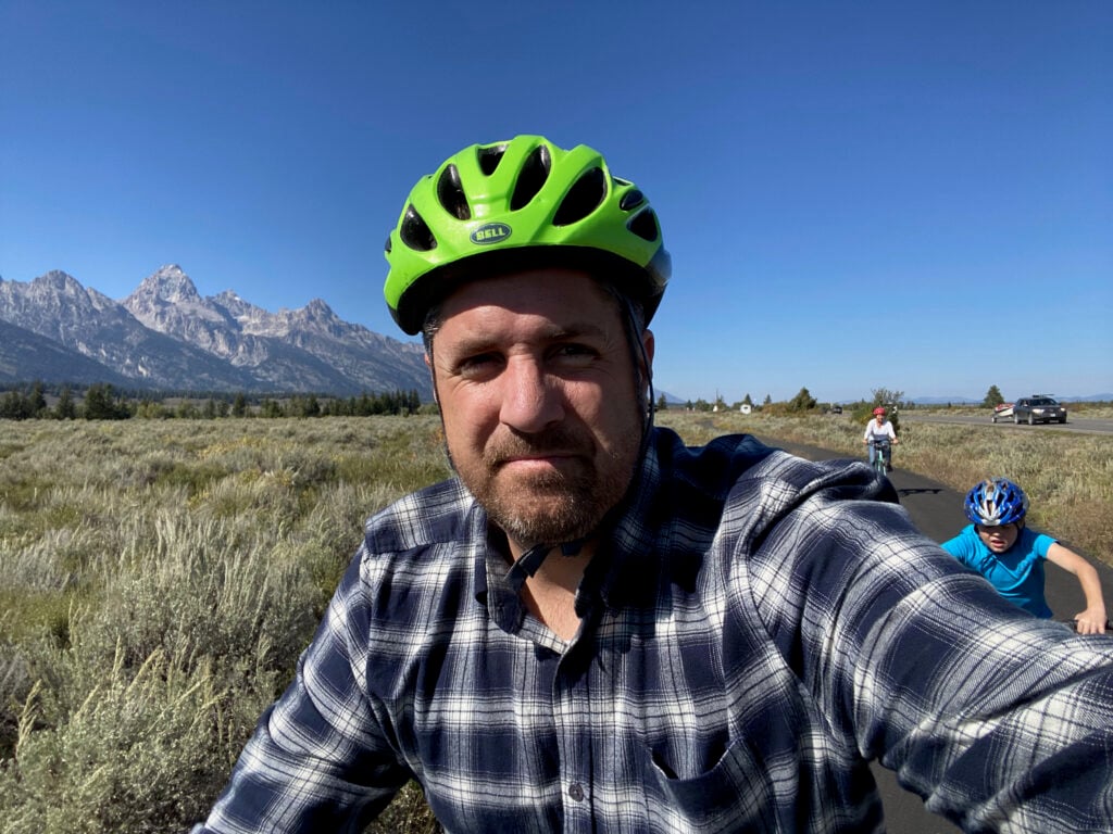 Man wearing bike helmet and biking in Grand Teton
