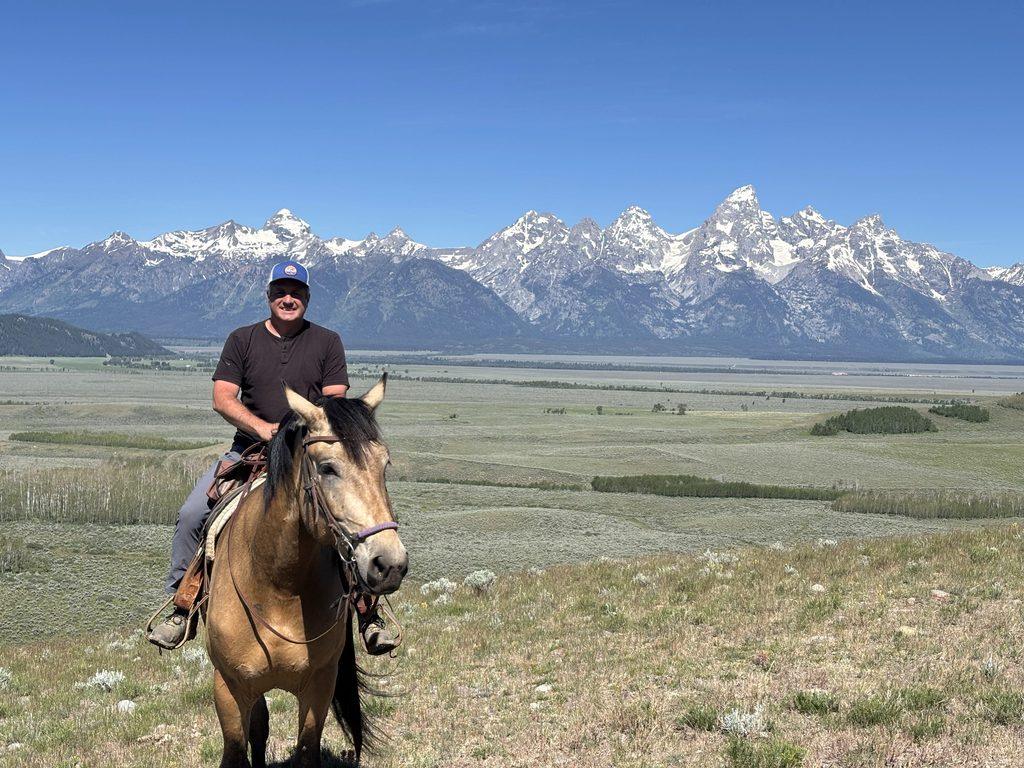 man on horseback ride in mountains