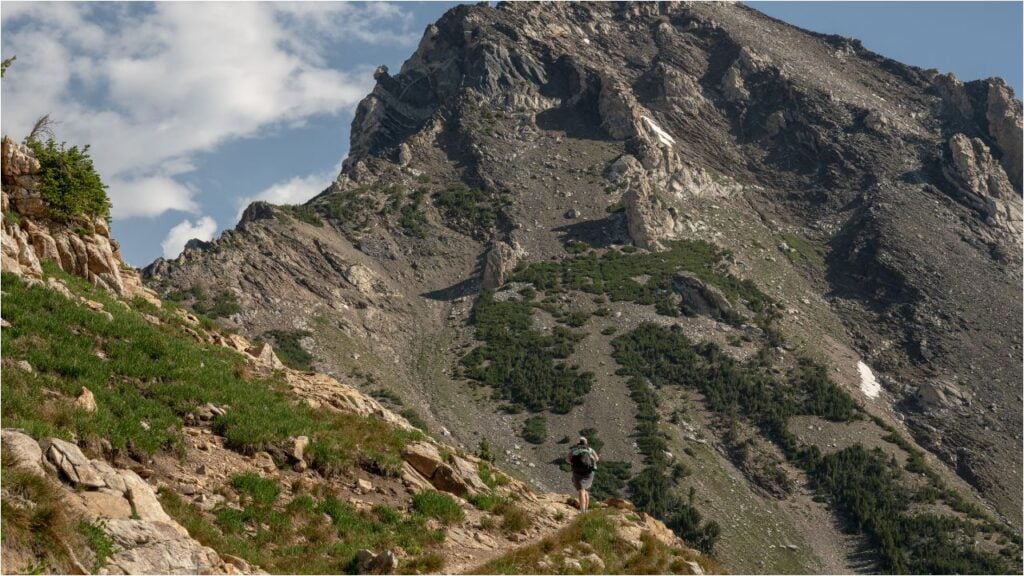 hiker walking on trail in canyon