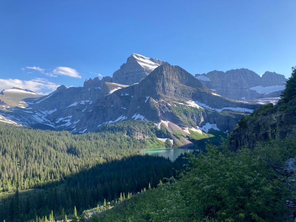 view of turquoise lake in the mountains in the distance
