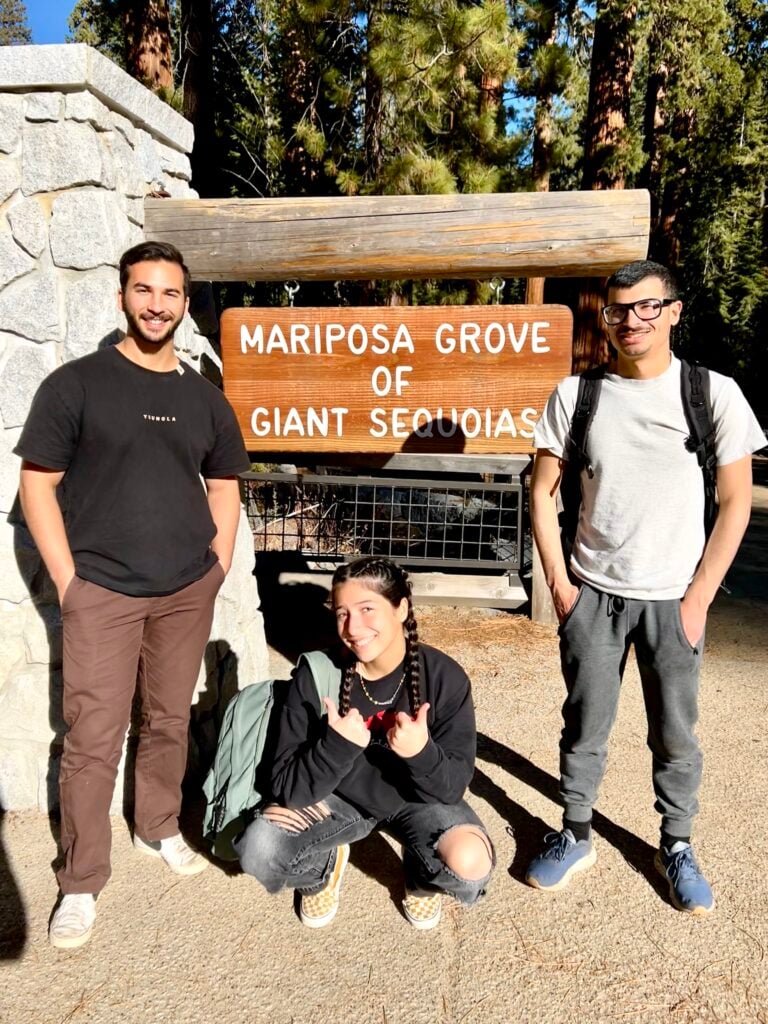 people standing in front of visitor center sign