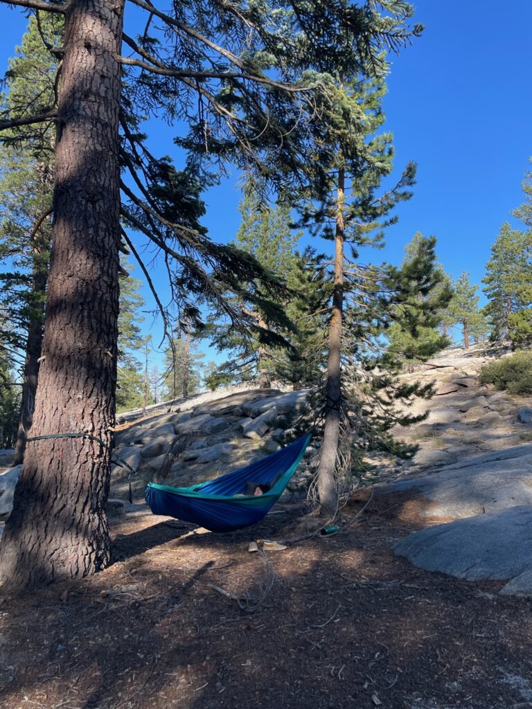girl in hammock between trees