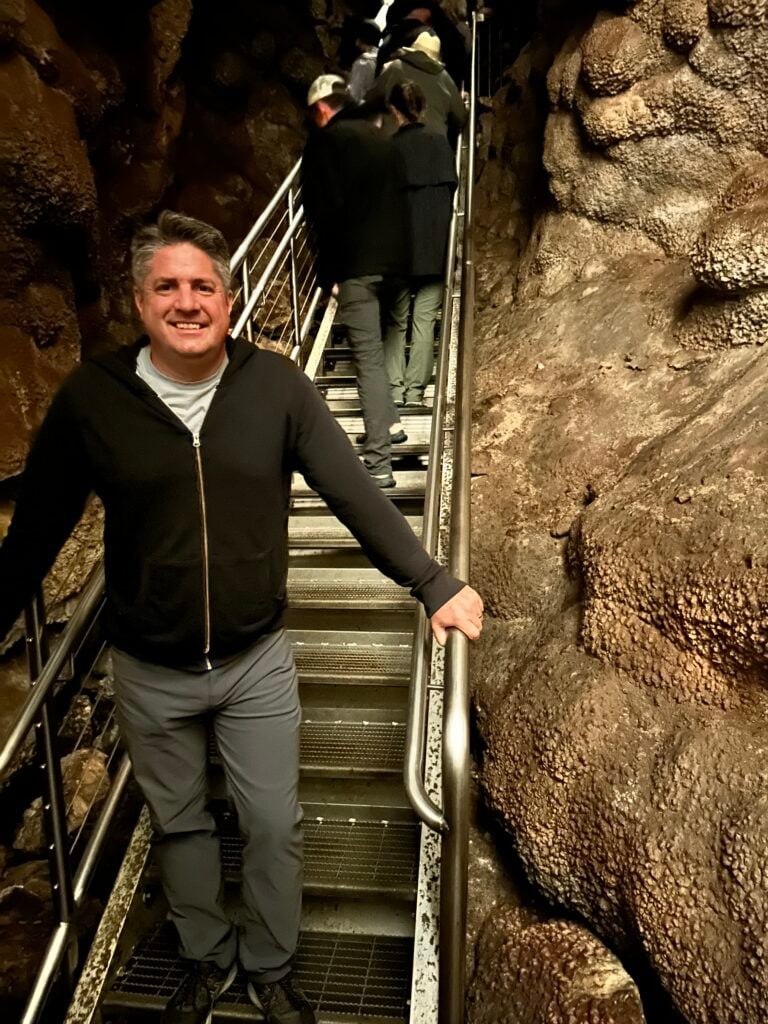 man on stairs in cave