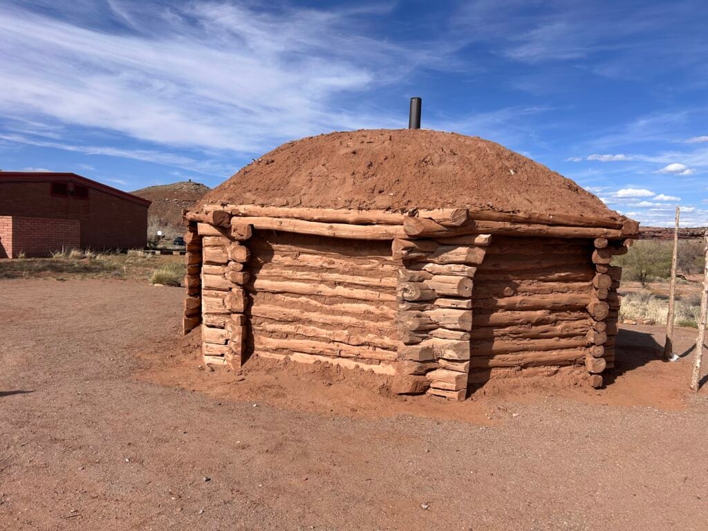 Hogan house with mud roof and logs
