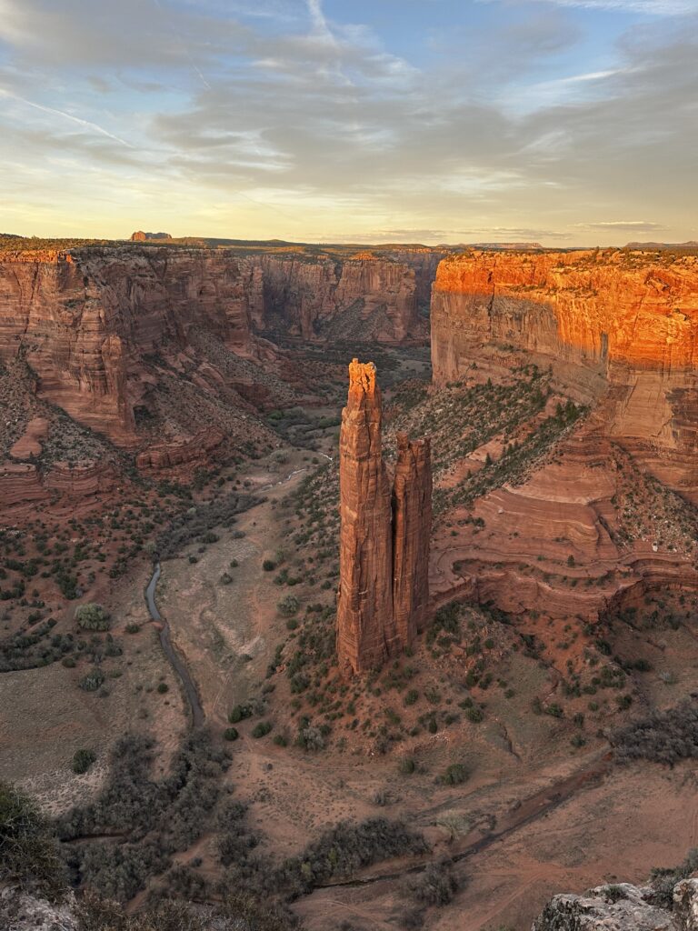 Sunset over a red rock canyon with a spire in the middle