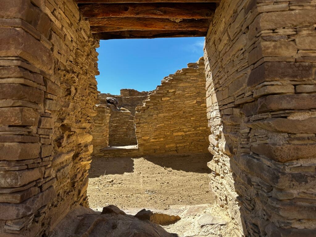 Stone doorway to an ancient ruin with a dirt floor