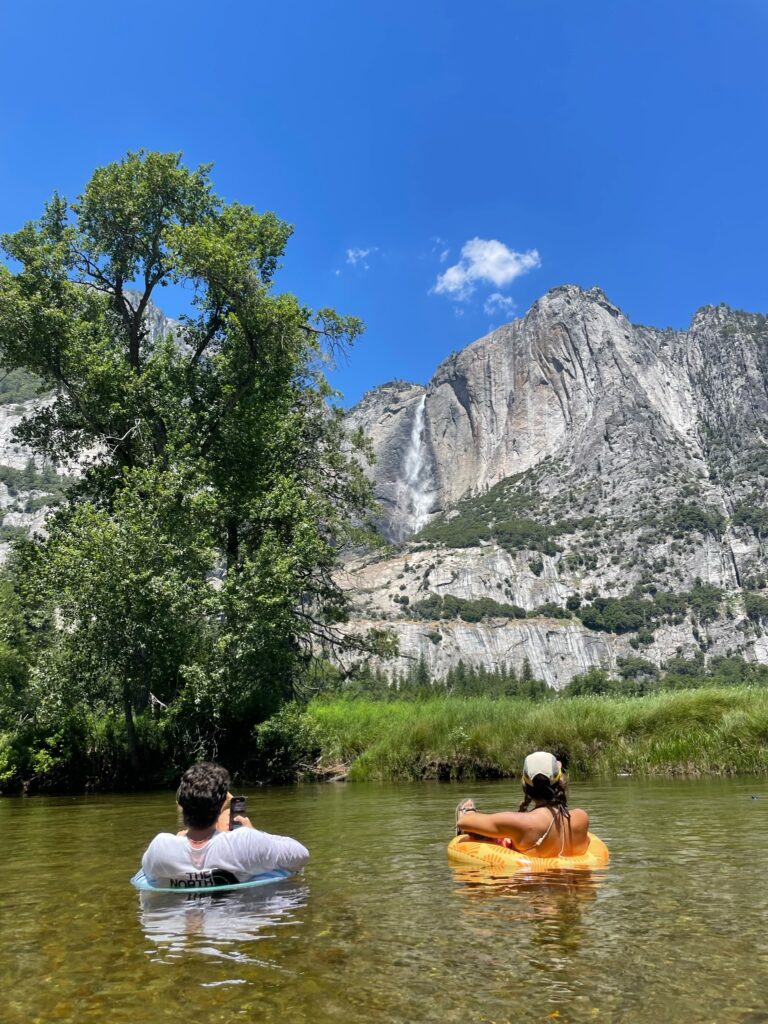 people floating on tubes in river