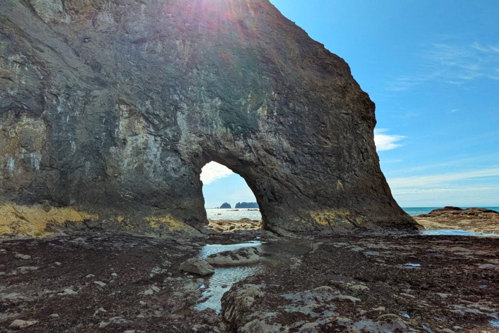 hole in rocky cliff on beach