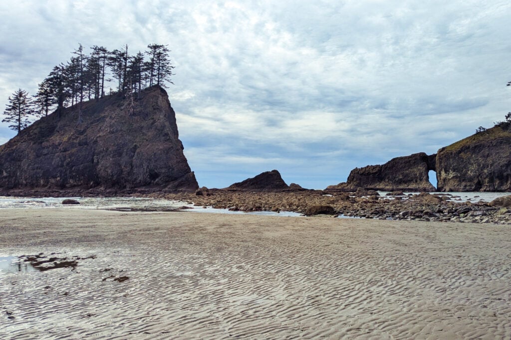 sandy beach with rocks and cliffs