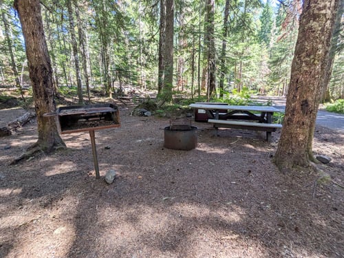 picnic table, fire ring, and grill at campsite
