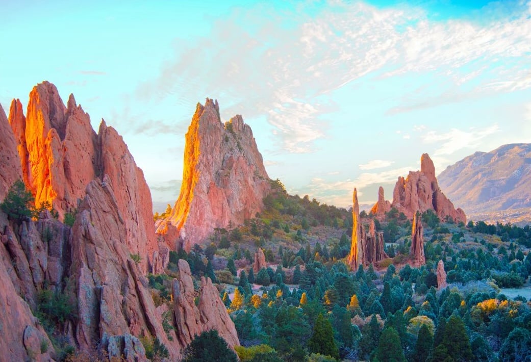 Red sandstone formations rising above trees at Garden of the Gods
