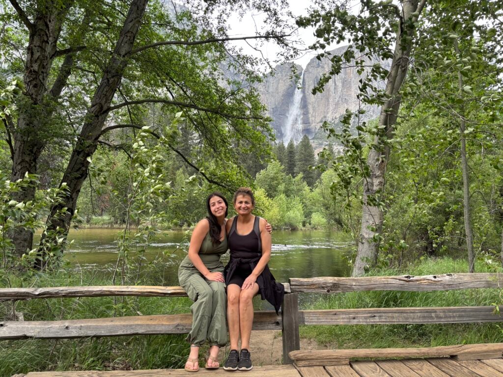 people sitting in front of waterfall
