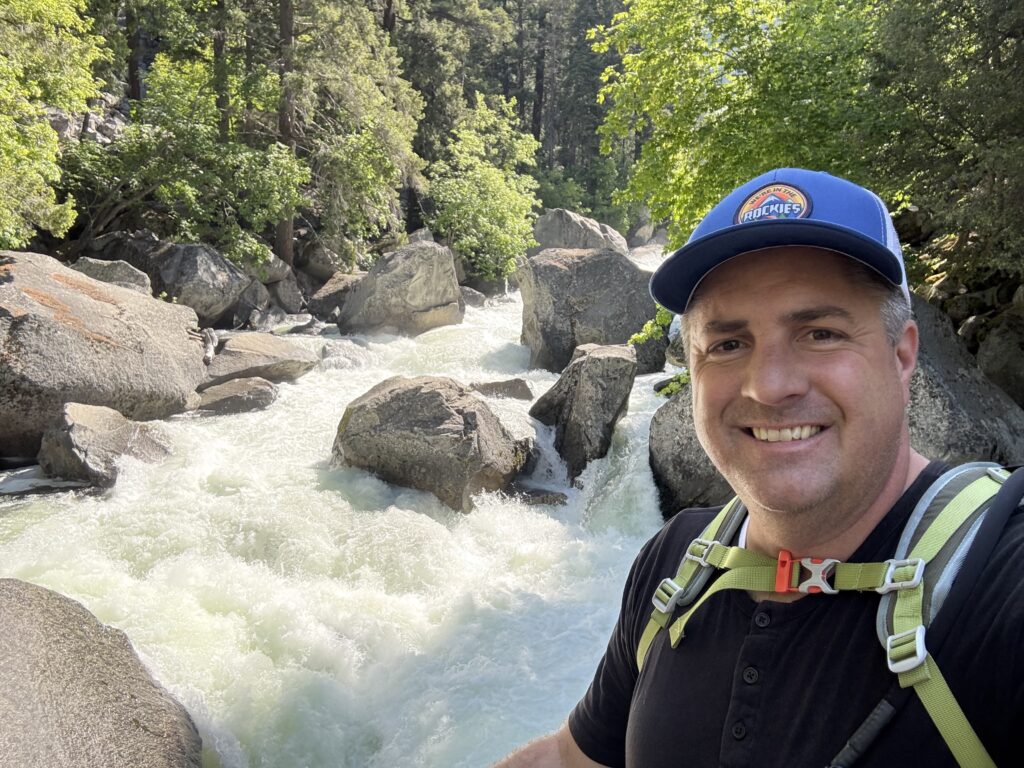 man in front of roaring river