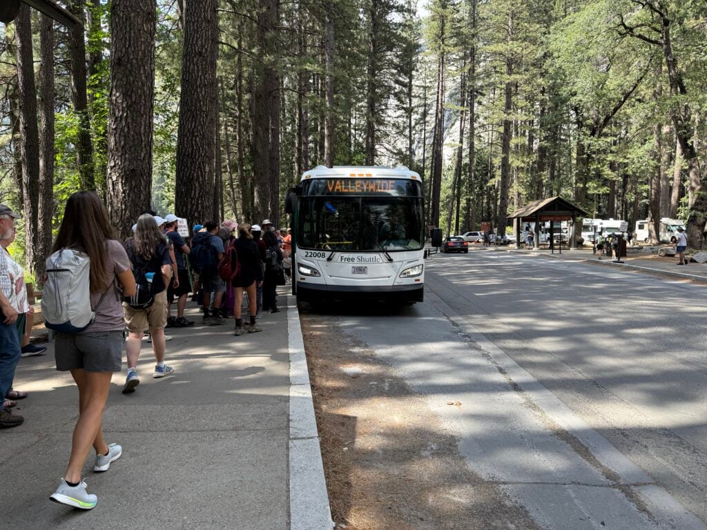 line waiting to get on the shuttle bus