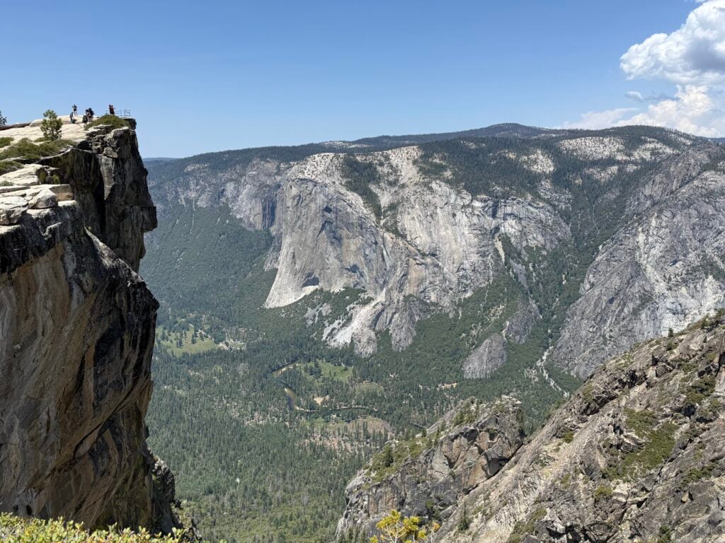 people on cliff edge in distance