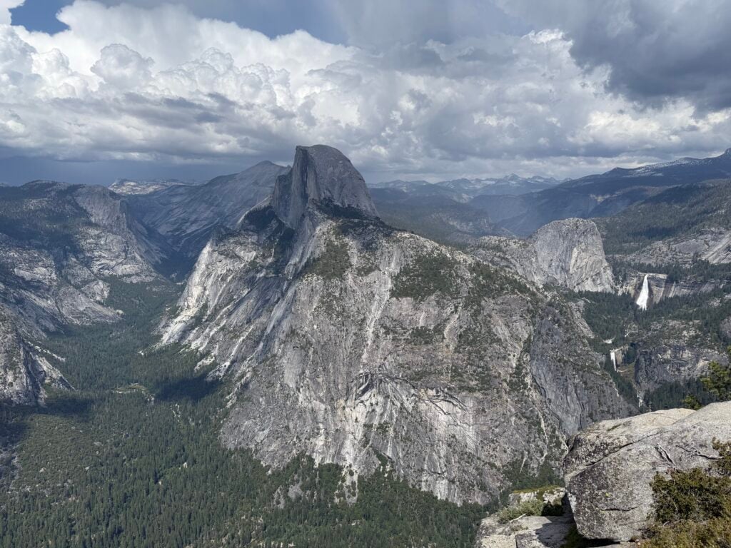 view of mountains, valley and waterfall