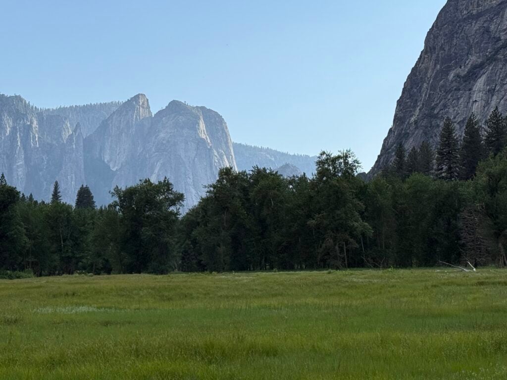 view of meadow with mountains in the distance