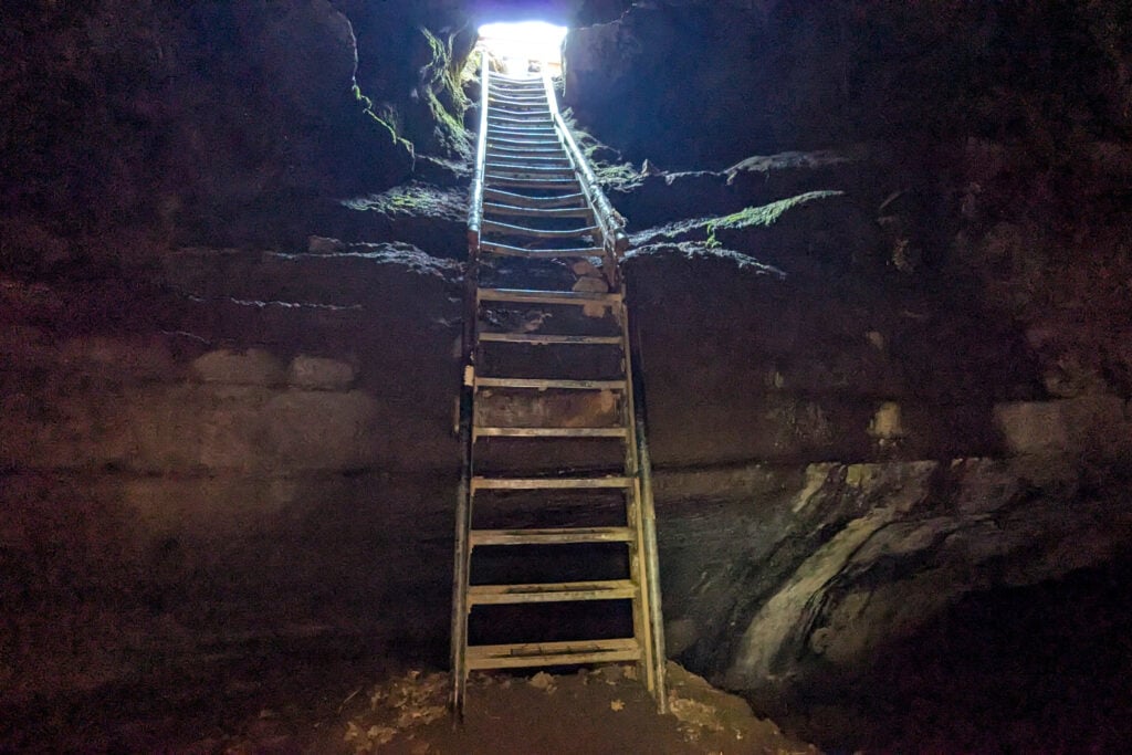 ladder leading upwards out of cave